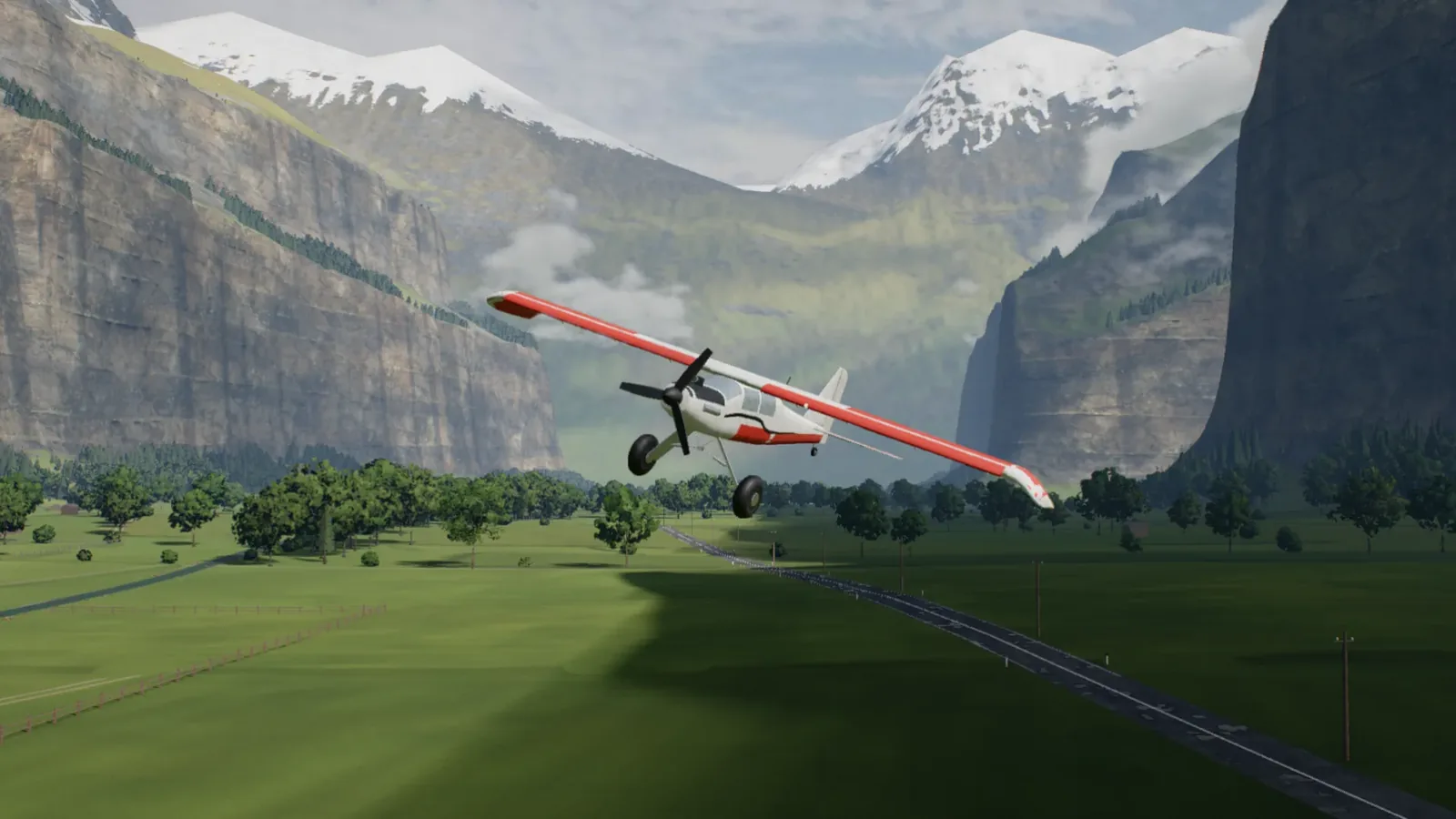 A red and white RC trainer banking toward the camera low over the valley floor, snowy peaks behind, rendered in the simulator.